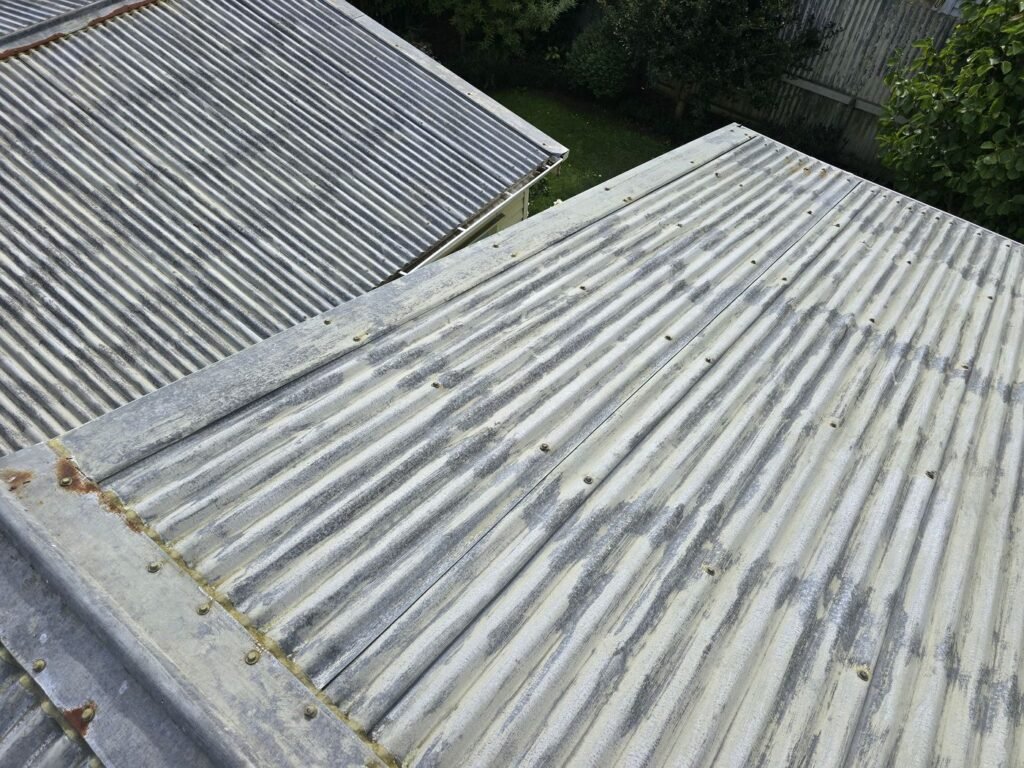 Rusted roofing sheets on a Hamilton roof before repair