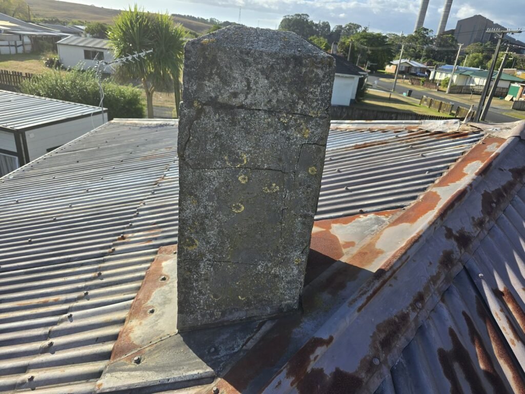 Rusted chimney flashing on the Huntly roof before the reroof