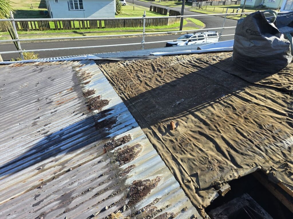 Old roofing iron being stripped from the Huntly house